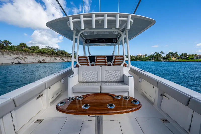 Seas The Day Yacht Photos Pics 2020 Jupiter 43 boat interior with seating and table on calm water.