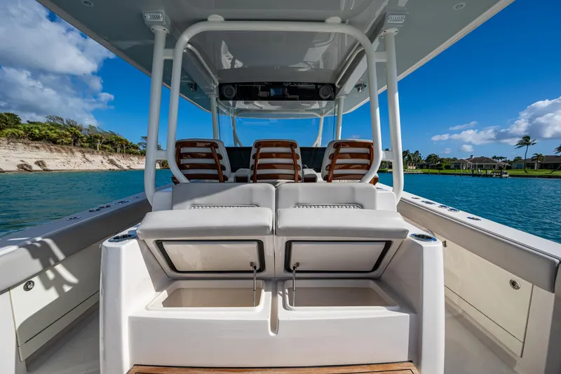 Seas The Day Yacht Photos Pics 2020 Jupiter 43 boat interior with seating, ocean view, and clear blue sky.