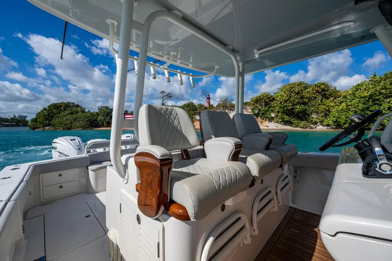 Seas The Day Yacht Photos Pics Luxurious seating on a 2020 Jupiter 43 boat, with scenic ocean backdrop.