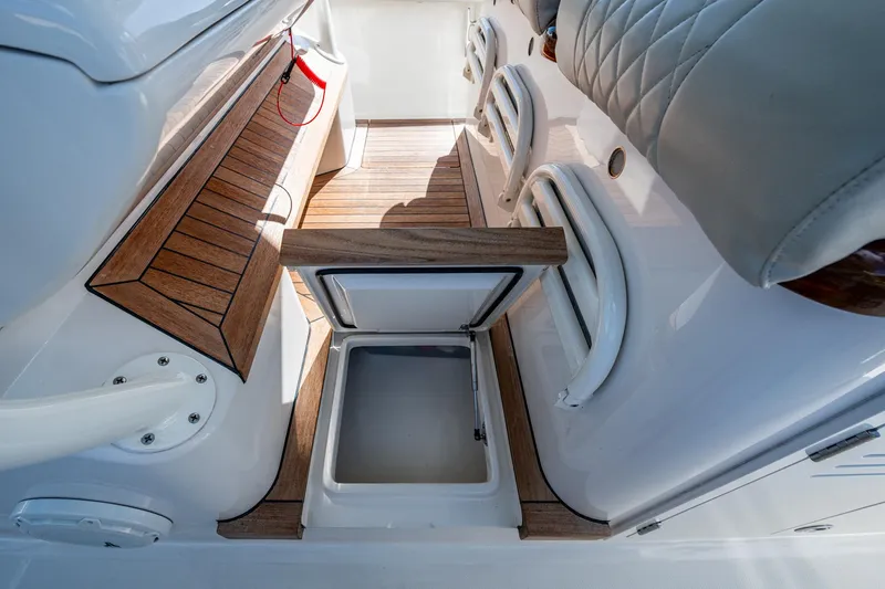 Seas The Day Yacht Photos Pics Interior of 2020 Jupiter 43 boat with open storage compartment and wooden flooring.