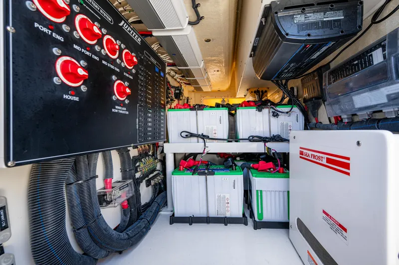 Seas The Day Yacht Photos Pics Electrical system of a 2020 Jupiter 43 boat, featuring batteries and control panels.
