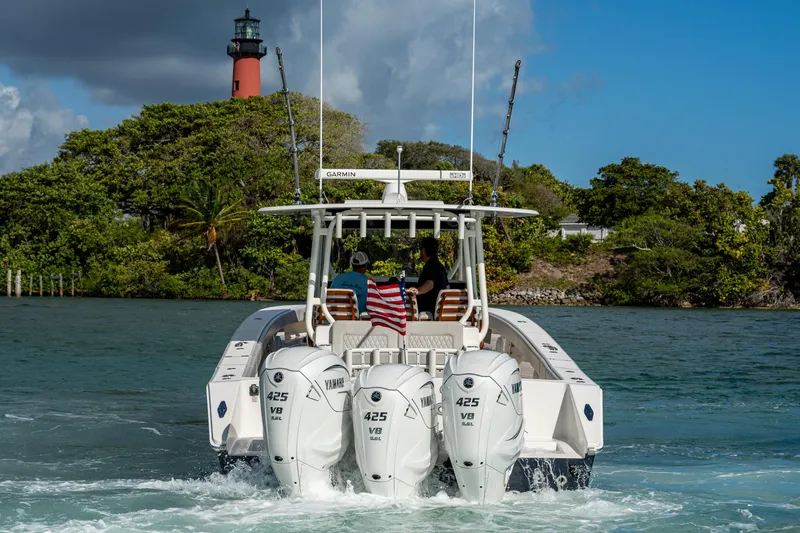 Seas The Day Yacht Photos Pics Jupiter 43 boat with triple Yamaha engines near lighthouse, 2020 model.