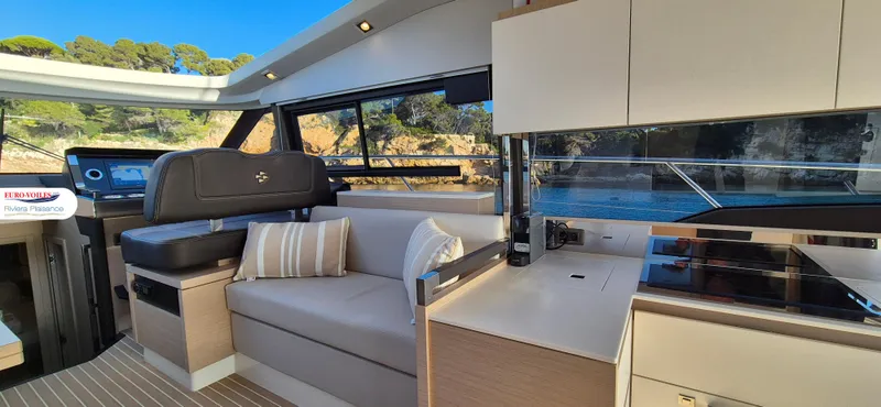 Good Spirit Yacht Photos Pics Interior of 2024 Prestige 460S yacht with modern seating and kitchen area.