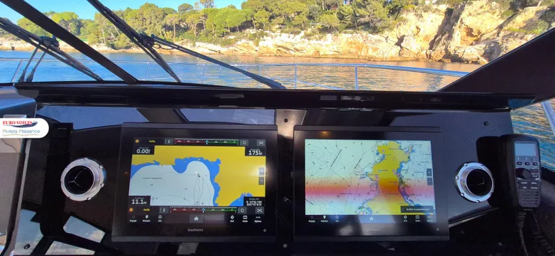 Good Spirit Yacht Photos Pics 2024 Prestige 460S yacht dashboard with navigation screens, near scenic coastline.