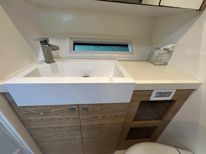  Yacht Photos Pics Modern bathroom sink in 2019 Xquisite Yachts X5, featuring sleek design and wood cabinetry.