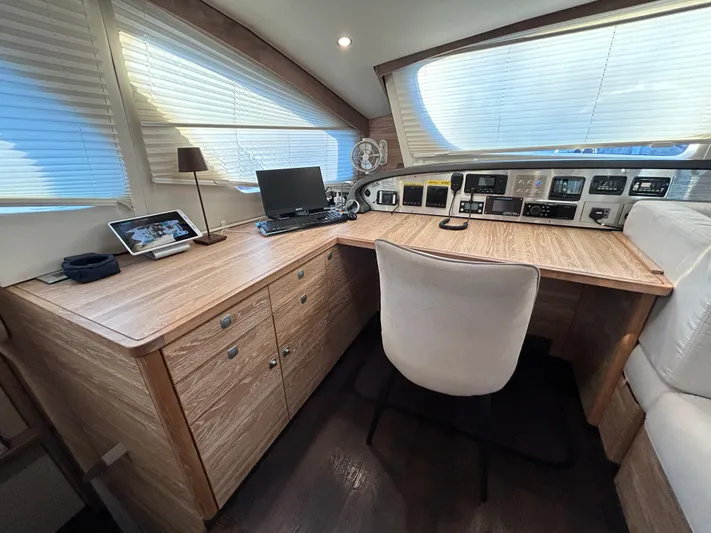  Yacht Photos Pics Luxurious 2019 Xquisite Yachts X5 interior with modern navigation station and wooden cabinetry.
