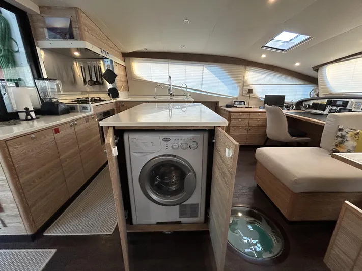  Yacht Photos Pics Luxurious 2019 Xquisite Yachts X5 interior with modern kitchen and integrated washing machine.