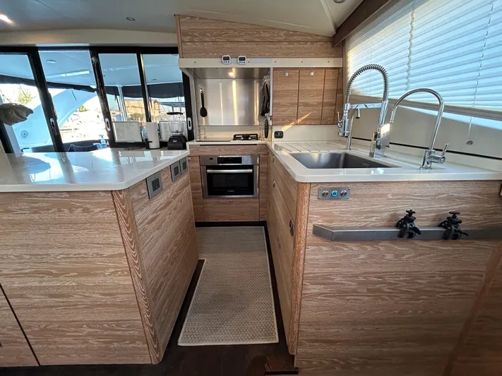  Yacht Photos Pics Luxurious 2019 Xquisite Yachts X5 kitchen with modern appliances and wood finish.
