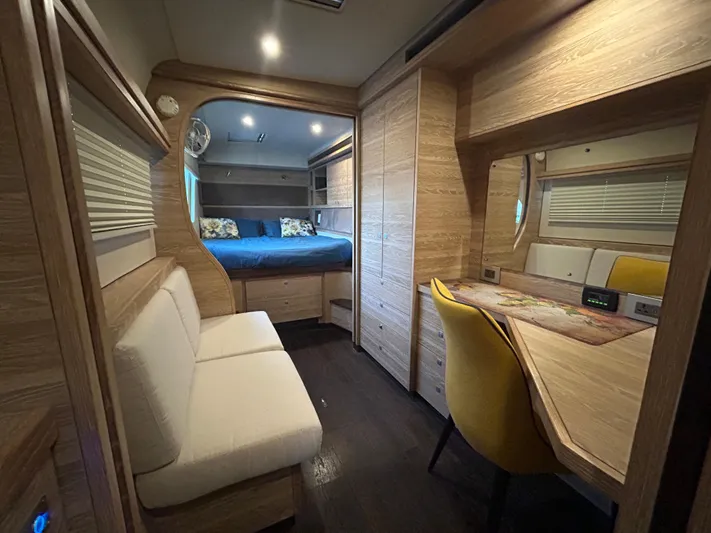  Yacht Photos Pics Luxurious 2019 Xquisite Yachts X5 interior with cozy seating, desk, and bed.