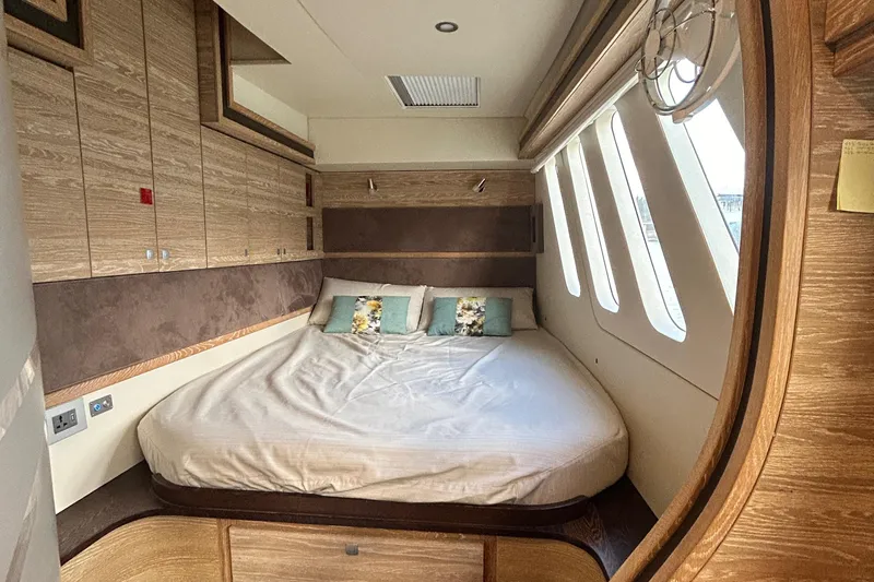  Yacht Photos Pics Luxurious 2019 Xquisite Yachts X5 cabin with cozy bed and elegant wood finishes.