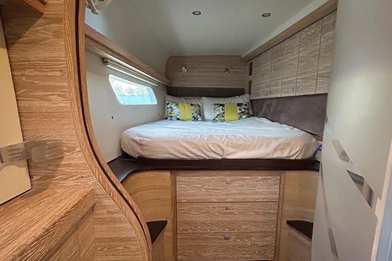  Yacht Photos Pics Luxurious 2019 Xquisite Yachts X5 cabin with cozy bed and elegant wood finish.