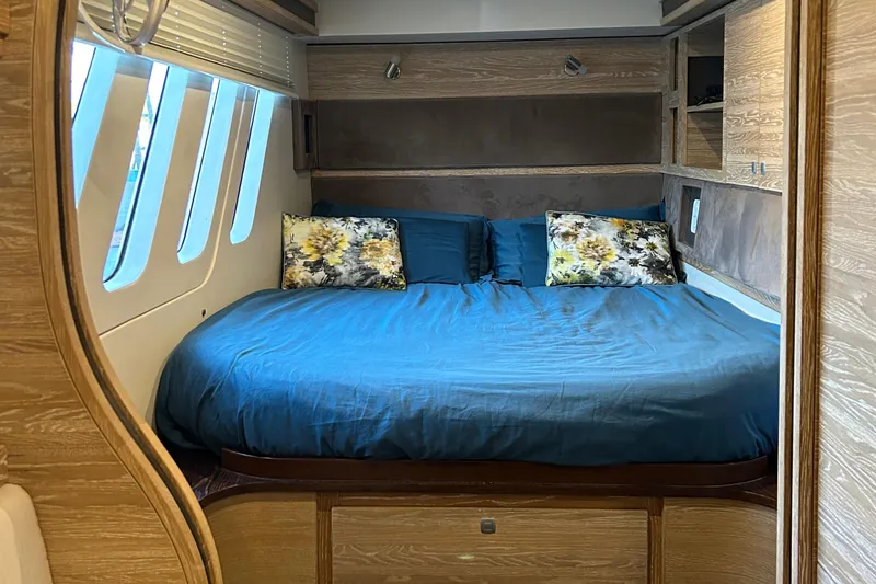  Yacht Photos Pics Luxurious bedroom interior of 2019 Xquisite Yachts X5, featuring a cozy bed and elegant design.