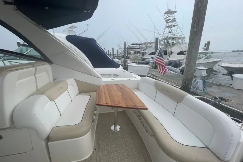 Catalyst Yacht Photos Pics 2009 Sea Ray 330 Sundancer yacht interior with seating and table, docked at marina.