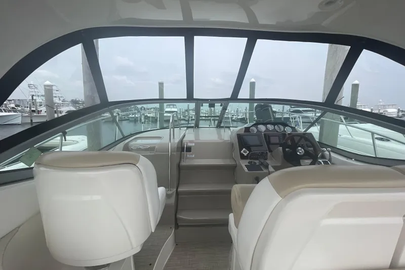 Catalyst Yacht Photos Pics Interior view of 2009 Sea Ray 330 Sundancer yacht cockpit with helm and seating.