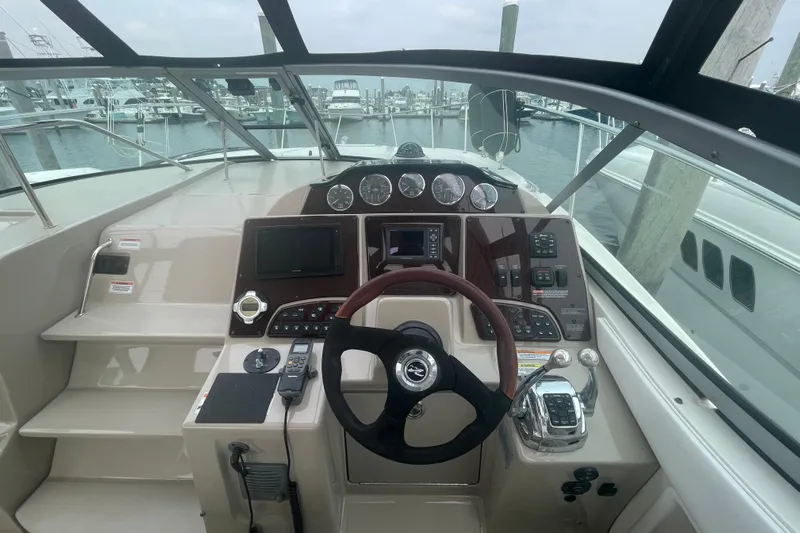 Catalyst Yacht Photos Pics Helm of 2009 Sea Ray 330 Sundancer with steering wheel and control panel, docked at marina.