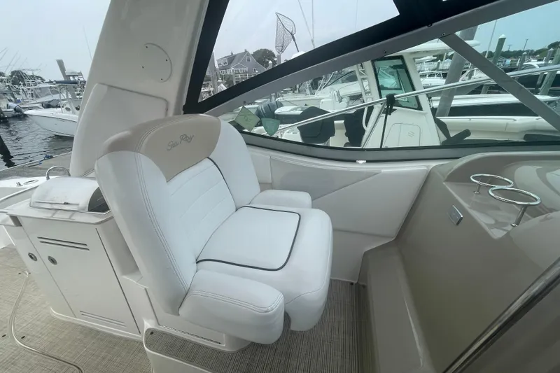 Catalyst Yacht Photos Pics 2009 Sea Ray 330 Sundancer cockpit with white seating and marina view.