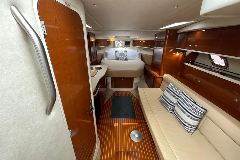 Catalyst Yacht Photos Pics 2009 Sea Ray 330 Sundancer interior with cozy seating, wooden finishes, and a comfortable bed.