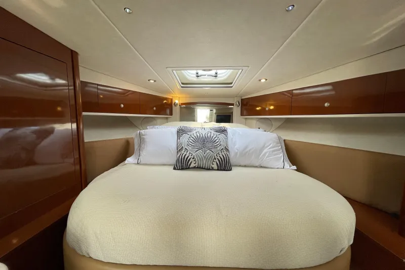 Catalyst Yacht Photos Pics Luxurious cabin interior of 2009 Sea Ray 330 Sundancer with cozy bed and elegant wood finish.