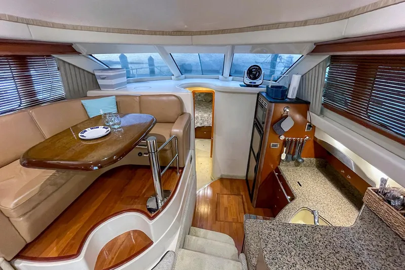 Still Waters Yacht Photos Pics Luxurious interior of 2007 Sea Ray 44 Sedan Bridge yacht with dining area and kitchen.