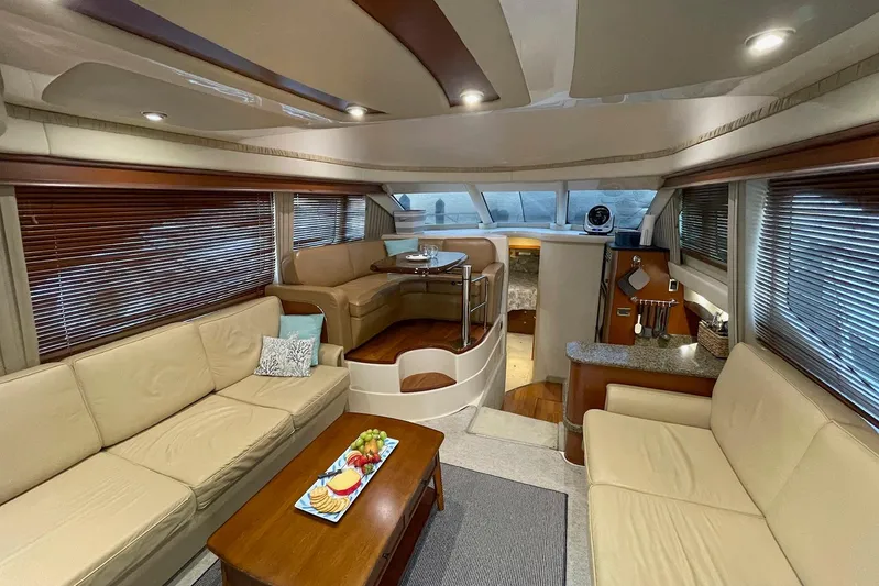 Still Waters Yacht Photos Pics Luxurious interior of 2007 Sea Ray 44 Sedan Bridge yacht with elegant seating and dining area.