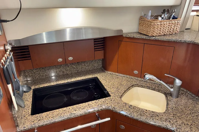 Still Waters Yacht Photos Pics Luxurious 2007 Sea Ray 44 Sedan Bridge yacht kitchen with granite countertops and modern amenities.