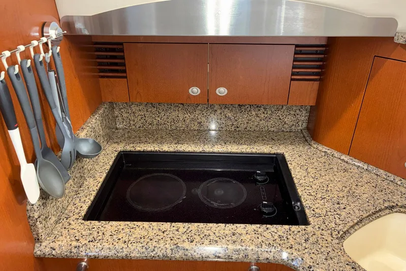 Still Waters Yacht Photos Pics 2007 Sea Ray 44 Sedan Bridge kitchen with granite countertop and electric stove.