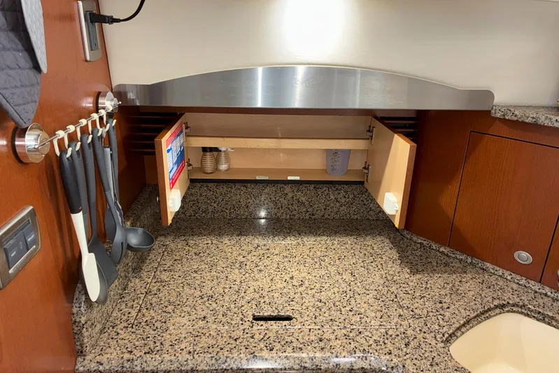 Still Waters Yacht Photos Pics 2007 Sea Ray 44 Sedan Bridge kitchen with granite countertop and utensil storage.