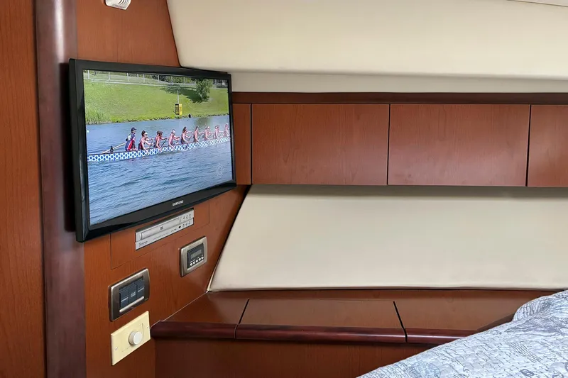 Still Waters Yacht Photos Pics 2007 Sea Ray 44 Sedan Bridge interior with TV and wooden cabinetry.