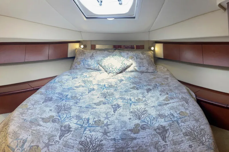 Still Waters Yacht Photos Pics Luxurious 2007 Sea Ray 44 Sedan Bridge cabin with elegant bedding and ambient lighting.