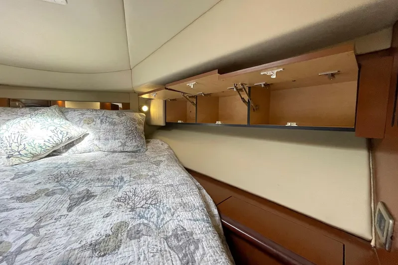 Still Waters Yacht Photos Pics 2007 Sea Ray 44 Sedan Bridge cabin with open storage and patterned bedding.