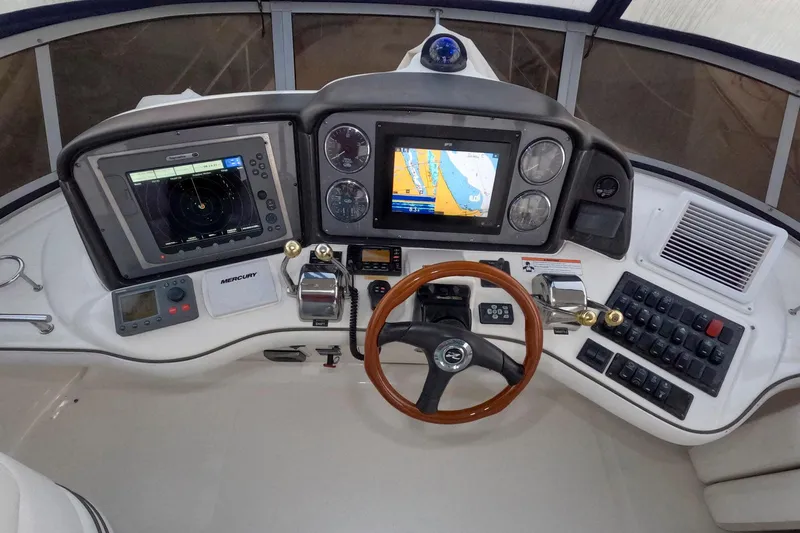 Still Waters Yacht Photos Pics 2007 Sea Ray 44 Sedan Bridge helm with navigation screens and controls.