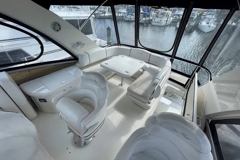 Still Waters Yacht Photos Pics 2007 Sea Ray 44 Sedan Bridge interior with white seating and marina view.