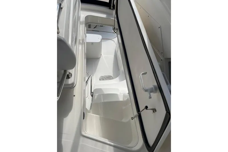 Still Waters Yacht Photos Pics 2007 Sea Ray 44 Sedan Bridge storage compartment with open hatch, showcasing interior space.