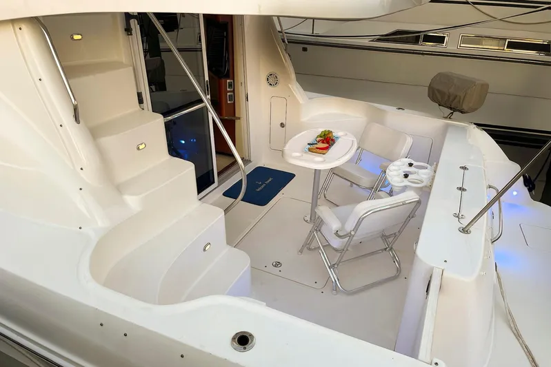 Still Waters Yacht Photos Pics 2007 Sea Ray 44 Sedan Bridge yacht deck with seating and table setup.