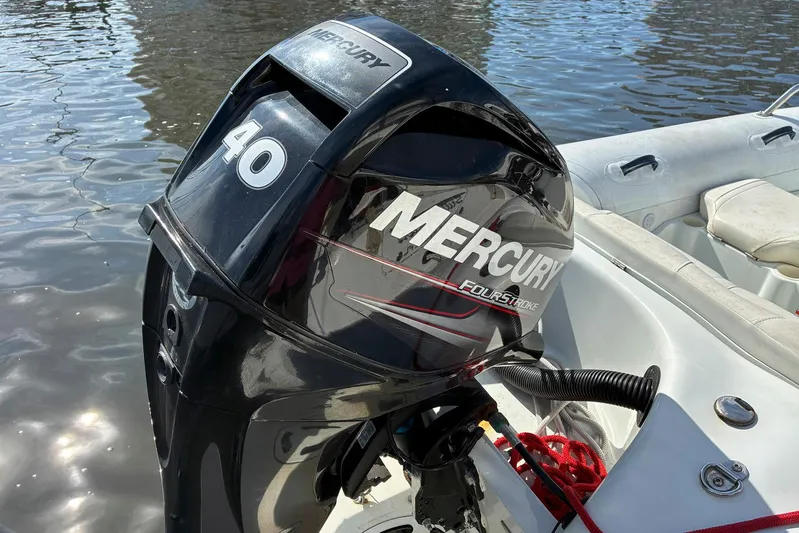 Still Waters Yacht Photos Pics Mercury 40 horsepower outboard motor on a boat, near water. Sea Ray 44 Sedan Bridge, 2007.