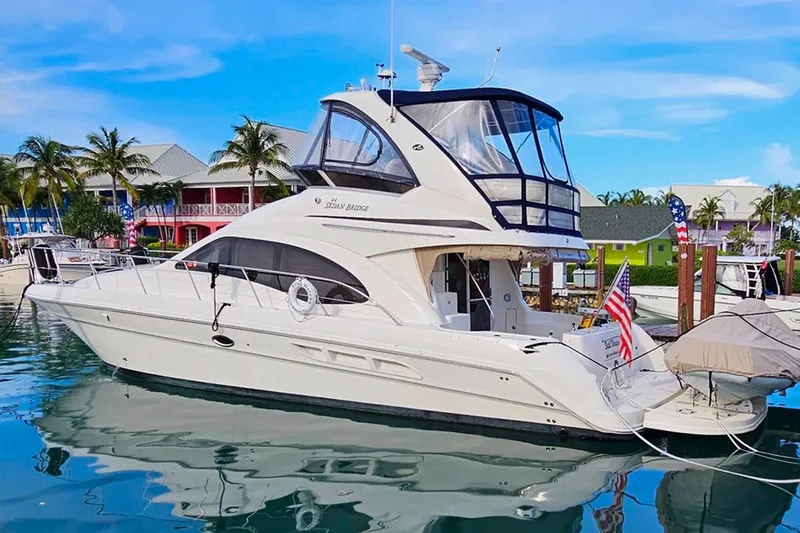 Still Waters Yacht Photos Pics 2007 Sea Ray 44 Sedan Bridge yacht docked in a tropical marina setting.
