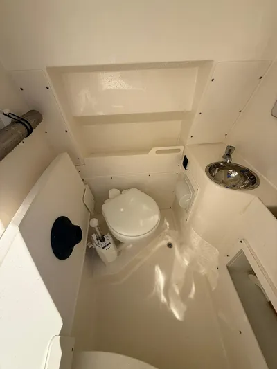  Yacht Photos Pics 2023 Pursuit S 268 Sport boat interior with toilet and sink.
