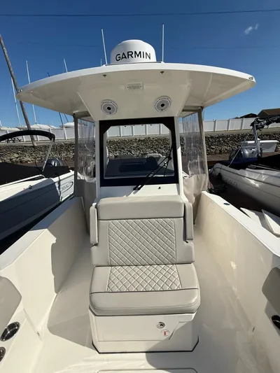  Yacht Photos Pics 2023 Pursuit S 268 Sport boat with Garmin equipment, featuring cushioned seating and sleek design.