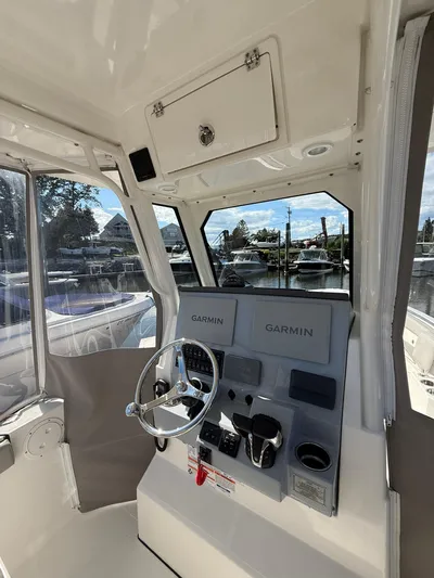  Yacht Photos Pics 2023 Pursuit S 268 Sport boat helm with Garmin navigation systems.