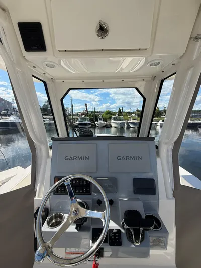  Yacht Photos Pics 2023 Pursuit S 268 Sport boat helm with dual Garmin displays at marina.