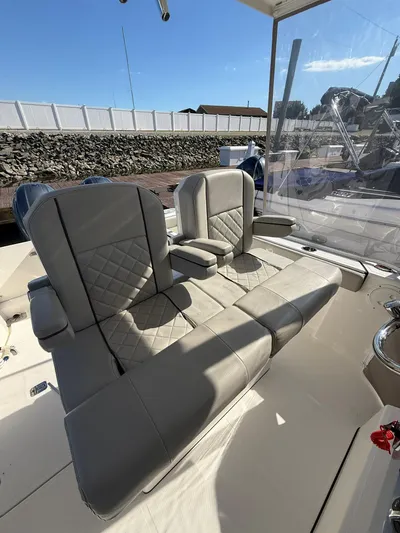 Yacht Photos Pics 2023 Pursuit S 268 Sport boat interior with cushioned seating and armrests.