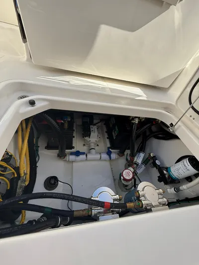  Yacht Photos Pics 2023 Pursuit S 268 Sport engine compartment with various cables and components.