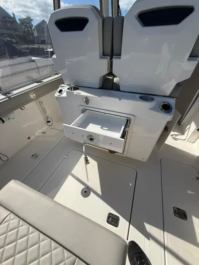  Yacht Photos Pics 2023 Pursuit S 268 Sport boat interior with seating and storage compartments.