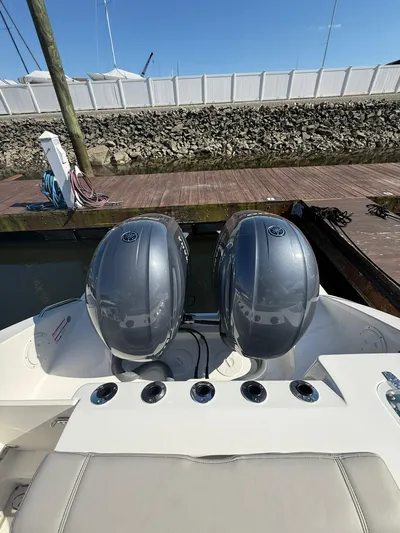  Yacht Photos Pics 2023 Pursuit S 268 Sport boat with dual outboard engines at dock.