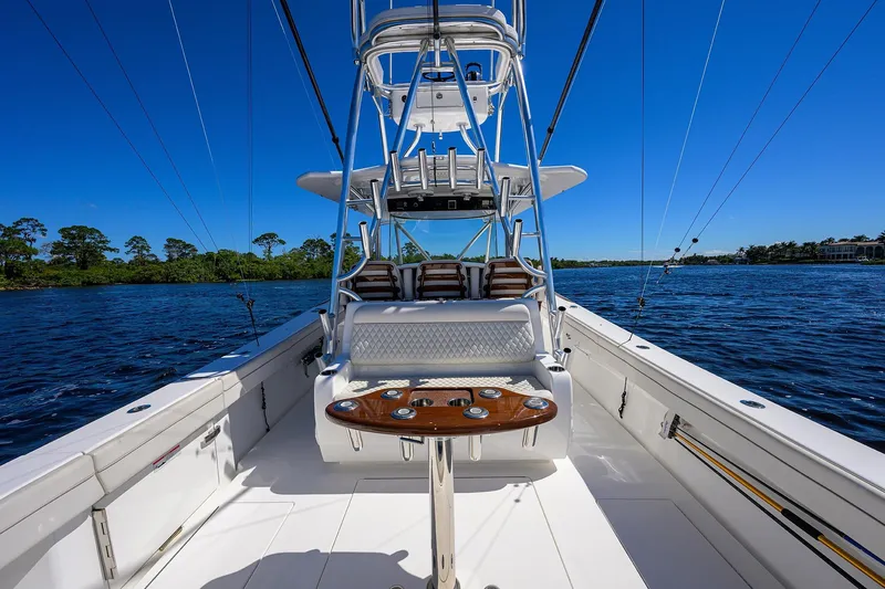 Miss Allied Yacht Photos Pics 2022 Valhalla V41 boat interior with fishing rods, blue sky, and water view.