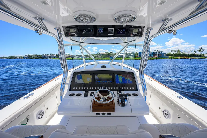 Miss Allied Yacht Photos Pics Cockpit view of 2022 Valhalla V41 boat with advanced navigation system on a sunny day.