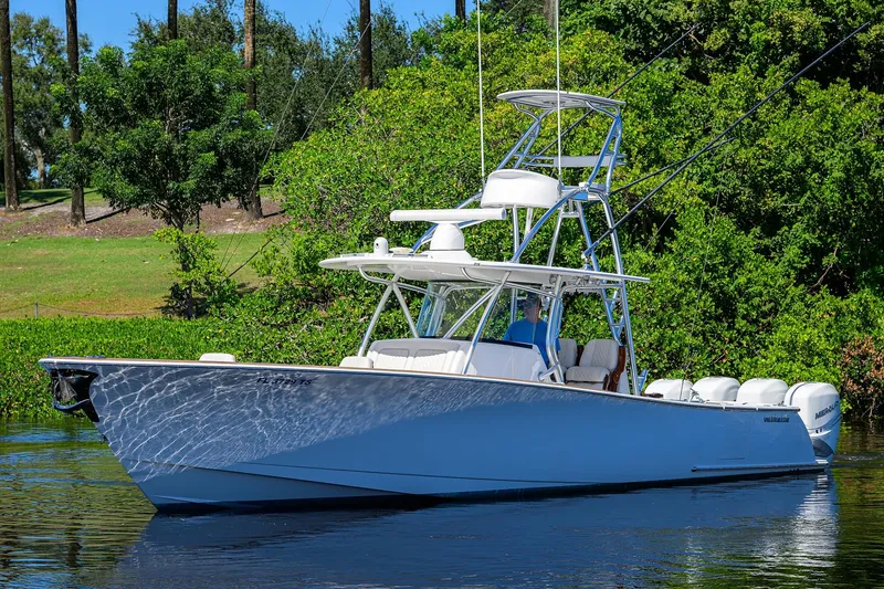 Miss Allied Yacht Photos Pics 2022 Valhalla V41 boat on calm water, surrounded by lush greenery.