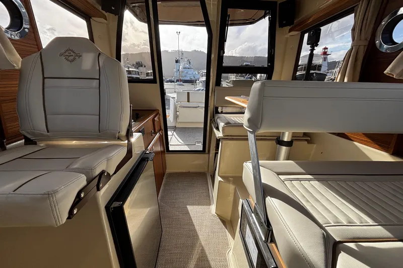  Yacht Photos Pics Interior of 2026 Ranger Tugs R-23 boat, featuring modern seating and cabinetry.