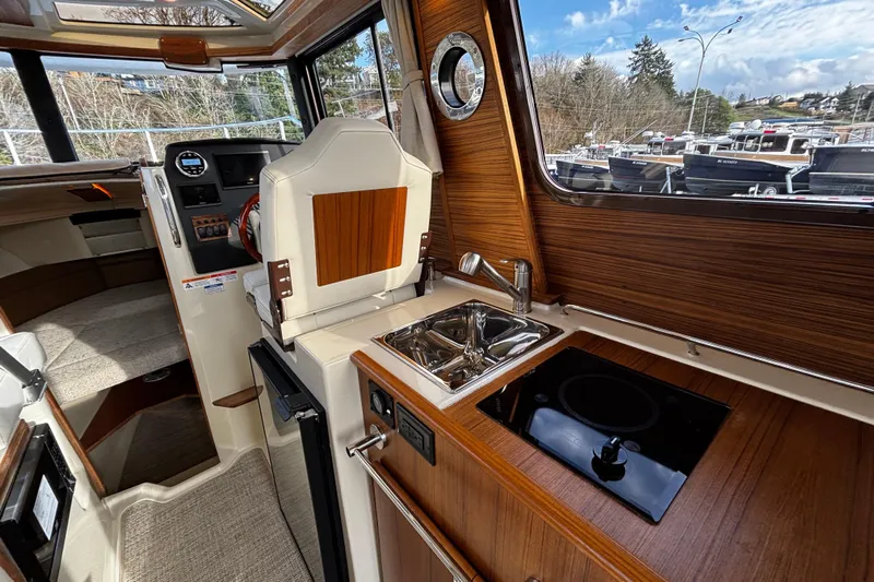  Yacht Photos Pics 2026 Ranger Tugs R-23 interior with kitchenette, sink, and control panel.