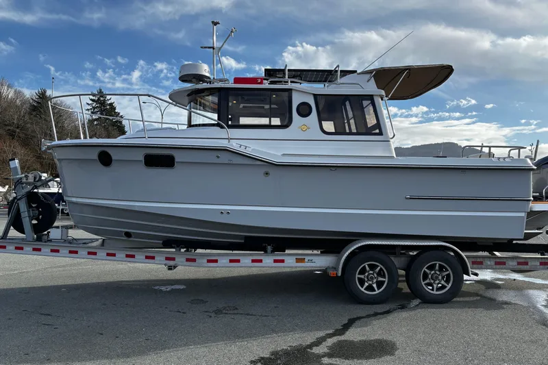  Yacht Photos Pics 2026 Ranger Tugs R-23 boat on trailer under cloudy sky.